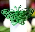 Close-up of laser-cut green butterfly napkin ring with intricate hollow patterns - Reflective Green