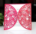Intricate laser-cut butterfly and floral patterns on a burgundy pearl paper wedding invitation - Pearlescent Red