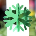 Metallic green snowflake napkin ring with a reflective finish for festive table decor - Reflective Green