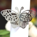 Elegant silver butterfly napkin ring with hollow design on white fabric - Reflective Silver