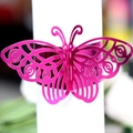 Exquisite laser-cut butterfly napkin ring in metallic rose pink for elegant wedding decor - Reflective Rose Red