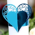 Elegant heart-shaped hollow napkin ring with intricate filigree in metallic blue finish - Reflective Blue