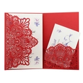 Macro view of laser-cut floral mandala wedding invitation with elegant white inserts - Pearlescent Red