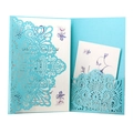 Macro detail of laser-cut hollow folder and floral inner card for wedding invitations - Tiffany Blue