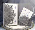 Close-up detail of a hollow laser cut grey invitation card with floral patterns - Charcoal Silver