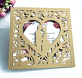 Detail of gold laser-cut wedding invitation featuring heart-shaped couple silhouette - Beige Gold