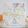 Cream laser-cut wedding invitation with champagne silk ribbon and floral insert - Ivory