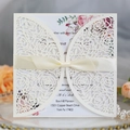 Elegant cream wedding invitation set with laser cut rose design and silk bow - Ivory