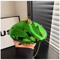 Macro detail of emerald green acrylic bag with liquid texture and gold chain strap - Green