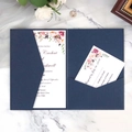 Elegant navy blue laser-cut wedding invitation set with floral insert on marble - Ink Blue