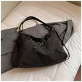 Large black shoulder tote bag in matte suede texture with metal buckle on light bedding - Coffee without Pendant