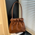 Brown faux suede bucket bag with stylish drawstring pleated closure and thin shoulder straps - Brown