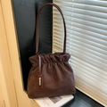Minimalist dark brown suede bucket bag with drawstring closure and slim shoulder strap - Brown