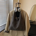 Deep brown large tote bag in matte suede hanging with chic trench coat and headphones - No Pendant / Brown