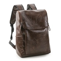 Detail view of dark brown retro leather backpack with side pockets and adjustable straps - Brown