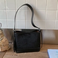Detail of minimalist black tote bag featuring spliced suede and smooth leather textures - Black