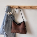 Brown suede tote bag with black leather straps and AHE embroidery in a rustic setting - Brown No Pendant