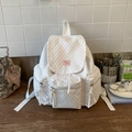 Zaino bianco con motivi a stelle rosa e tasche multiple con cerniera su una scrivania - Bianco