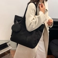 Large black corduroy tote bag with small round pouch shown on a model for daily commute - Black