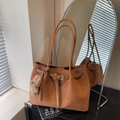 Brown woven tote bag with shoulder straps and a plush bear charm on a book - Brown with Pendant