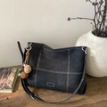 Detail of gray suede tote bag with contrast stitching and decorative pompom charm - Black with Pendant