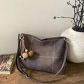 Retro brown tote bag with white contrast stitching and plush pompom charm on wooden surface - Coffee with Pendant