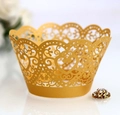 Detail of laser-cut heart pattern on gold pearlescent cupcake wrappers for weddings - Gold