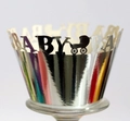 Macro view of silver laser-cut cupcake wrappers with BABY text and stroller motifs - 5x5x8CM / Reflective Silver