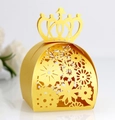 Detail of laser-cut floral pattern and crown top on a golden pearl paper candy box - Gold