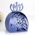 Close-up of laser-cut floral pattern and crown top on dark blue pearl paper gift box - Sapphire Blue