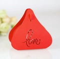 Detail of red triangular wedding favor box with laser-cut Love motif and heart - Red