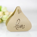 Close-up of golden pearlescent paper candy box with laser-cut Love heart patterns - Beige Gold