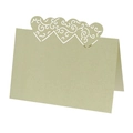 Macro detail of laser-cut heart pattern on pearlescent light green hollow table cards - Emerald Green