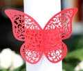 Macro view of red laser-cut butterfly napkin ring with fine hollowed-out wing details - Pearlescent Red