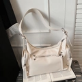 Chic beige shoulder bag with multiple functional zippers and trendy silver rivet details - White