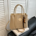 Elegant beige pebbled leather bucket bag with top handles and wooden bead charm - Gray