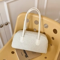 Chic white lamb wool shoulder bag with cream leather handles on a yellow chair - White