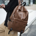 Detailed close-up of brown PU leather texture and durable zippers on a retro backpack - Yellow Brown