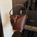 Dark brown bucket bag in lychee pattern leather with elegant gold hardware - Brown