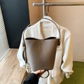 Minimalist dark taupe litchi grain leather bucket bag with slim shoulder strap - Gray