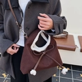Dark brown suede crossbody bag with plush white trim and a leather bow detail - Brown