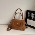 Brown leather boston bag with wide woven strap and silver hardware on marble surface - Brown No Pendant