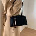 Black suede shoulder bag with retro wooden beads accessory in a minimalist studio setting - With Charm / Black