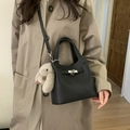 Black pebbled leather bucket bag with silver lock and grey plush rabbit charm - Black with Pendant