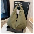 Detail of army green nylon hobo tote bag featuring side drawstrings and smooth texture - Green