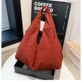 Detailed texture of large brick red canvas tote bag with wide shoulder strap - Burgundy