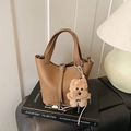 Bolso tipo cubo de cuero marrón con textura de lichi, cierre metálico y peluche - Con Colgante / Marrón