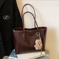 Dark brown oil-wax leather tote bag with plush dog charm on a silver suitcase - Coffee with Pendant