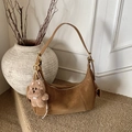 Brown leather hobo bag with teddy bear charm on a rustic minimalist background - Brown with Pendant