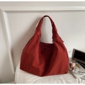 Detailed side view of a large rust orange nylon tote bag showing zipper and roomy interior - Orange